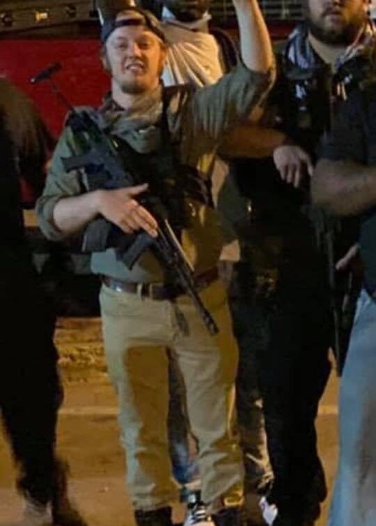 Luke Wenke with an assault rifle