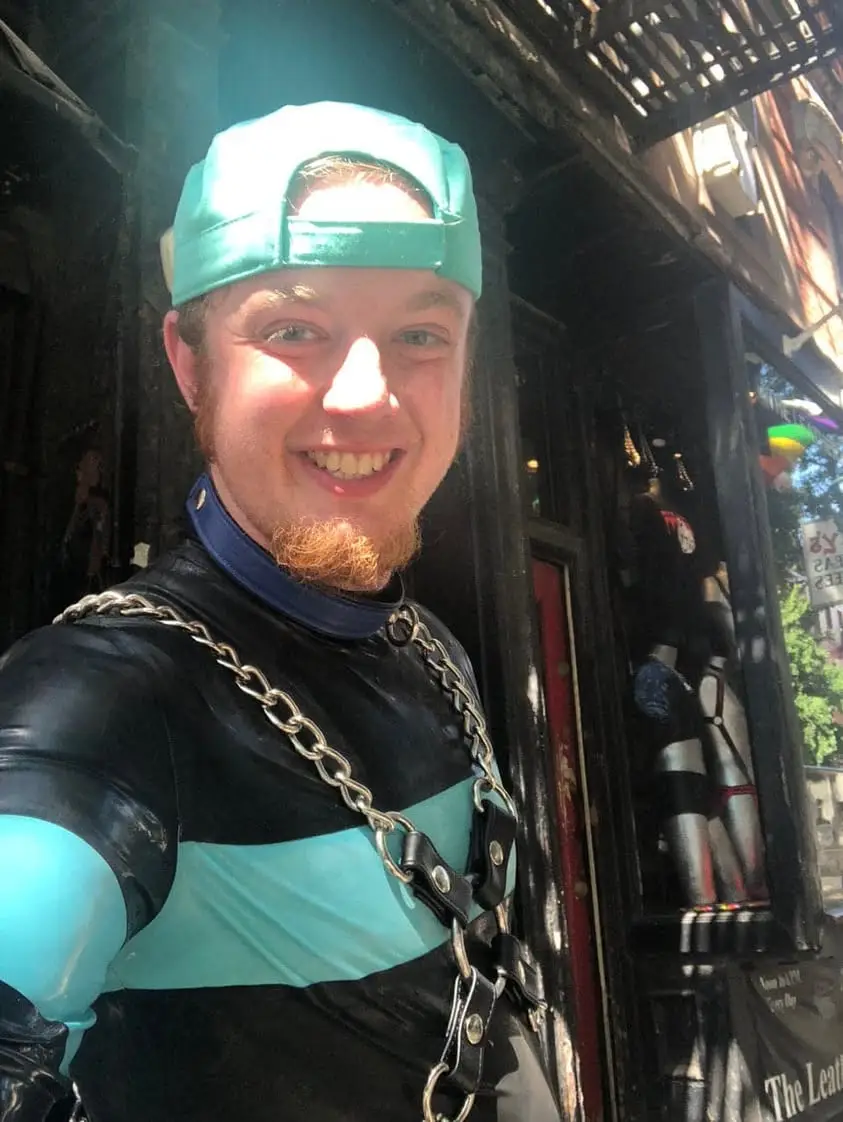 a selfie of luke wenke wearing bondage gear